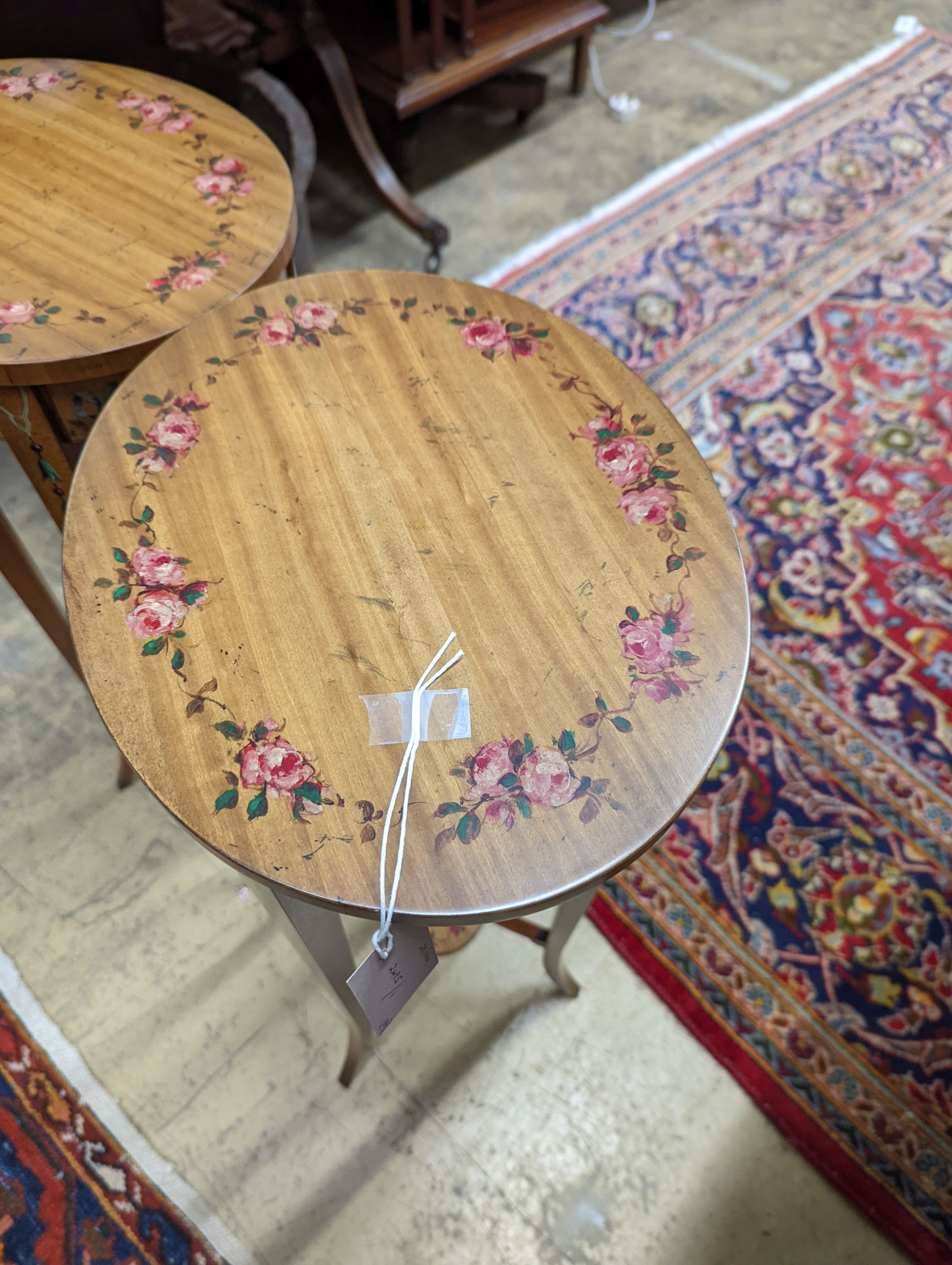 A pair of Sheraton style oval painted satinwood occasional tables, width 31cm, depth 26cm, height 71cm